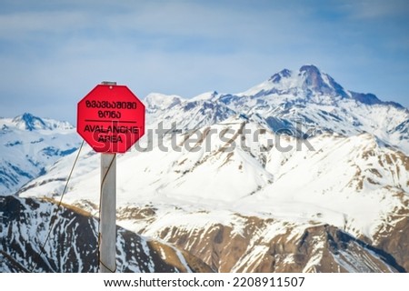 Avalanche sign post in Gudauri winter resort in Georgia caucasus mountains.