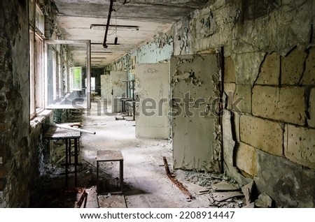 Disintegrating corridor in a Prypiat building. Chernobyl Exclusion Zone, Ukraine Royalty-Free Stock Photo #2208914447