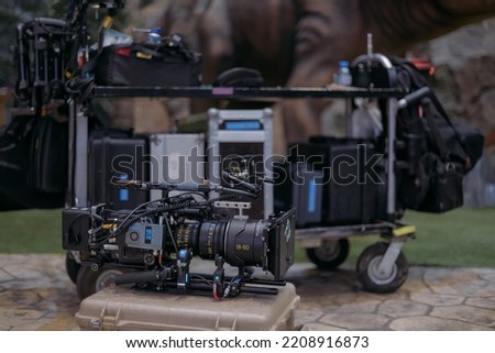 A professional film and video camera on the set. Filming day, equipment and crew. Technique of modern video filming.