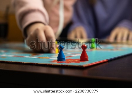Process of playing board game and having fun with friends and family, board game concept, hand playing and roll the dice.