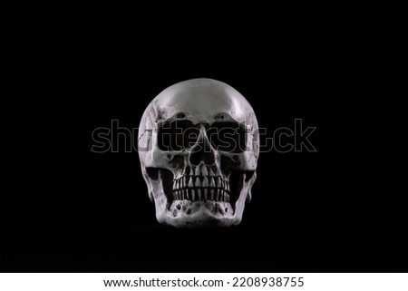 Halloween human skull on an old wooden table over black background. Shape of skull bone for Death head on halloween festival which show horror evil tooth fear and scary, copy space