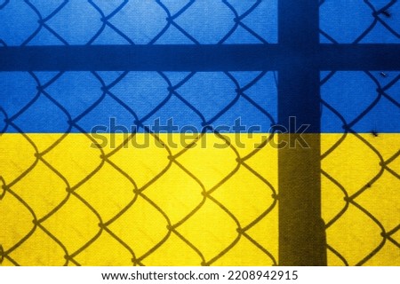 Backlight Backlight with physical Ukrainian flag and barbed wire. Prison concept with border image. Double exposure hologram.