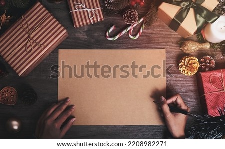 Christmas holiday greeting paper design mockup with decoration on wood table.