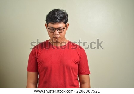 Asian young man looking down, sad and crying, bullied, sadness, child abuse concept, on white background Royalty-Free Stock Photo #2208989521