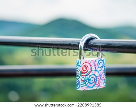 Locked red heart shaped padlock. Symbol of eternal love. Selective focus. The lock on handrail bar