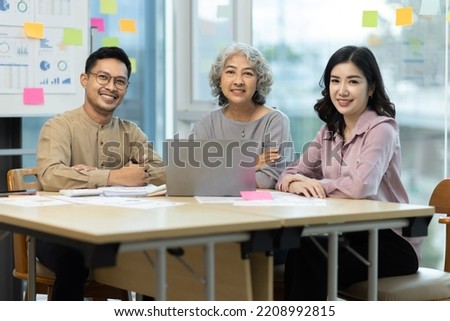 Asian business people meeting team  working with accounting documents and laptop at the table in office, Happy man working and business training to technology concept.