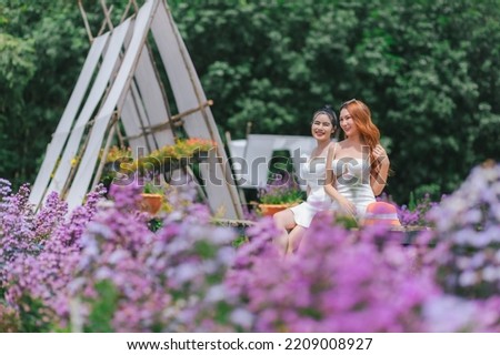 Beautyful two Asian women in the flower garden