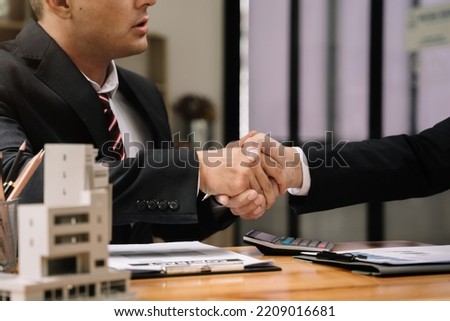 Close up two men shake hands at office negotiations. Making deal sign, conclude contract, formal greeting, strike bargain. Successful negotiations, insurance home loan concept.