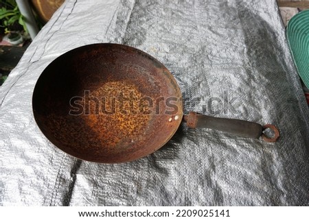    The old rusty pan has been used for a long time                            