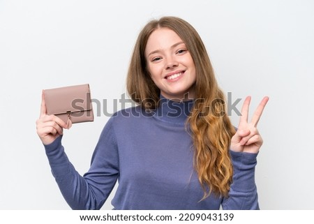 Young pretty woman holding wallet isolated on white background smiling and showing victory sign Royalty-Free Stock Photo #2209043139