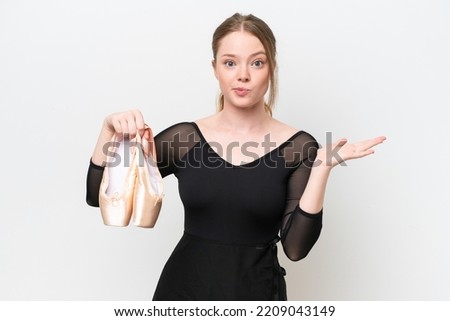 Young woman practicing ballet isolated on white background having doubts while raising hands