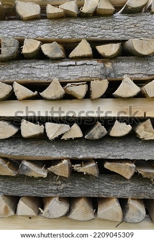 Neat stack of firewoods in a geometric pattern
