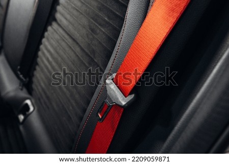Sports car seatbelt close up. Modern car red seatbelt and leather comfortable seat  Royalty-Free Stock Photo #2209059871