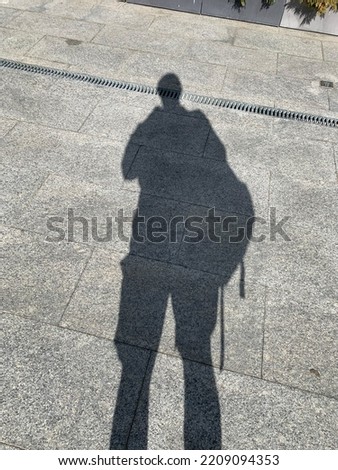 Men's shadow on a concrete background
