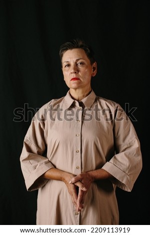 Dramatic portrait of a mature woman. Low key.