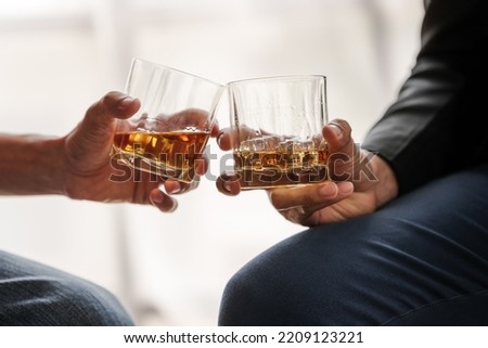Sad depressed addicted drunk guy, Alone asian man drinker alcoholic sitting at bar counter with glass drinking whiskey. with friends. Royalty-Free Stock Photo #2209123221