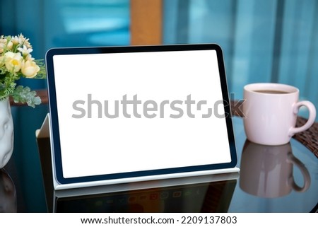 computer tablet with isolated screen on a table in a cafe