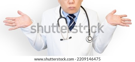 Male doctor raising both hands.