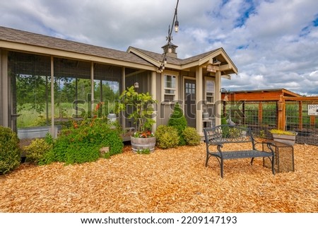 Exterior of estate style home on large landscaped lot with winding driveway expansive patio chicken coop and gardens full of flowers