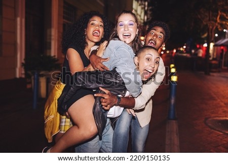 Crazy friends having fun together in the city. Multicultural young people shouting happily while hanging out together outdoors at night. Group of friends enjoying a great weekend together. Royalty-Free Stock Photo #2209150135