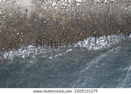 Light waves crash rocky shore at northern California beach during the evening Royalty-Free Stock Photo #2209155279