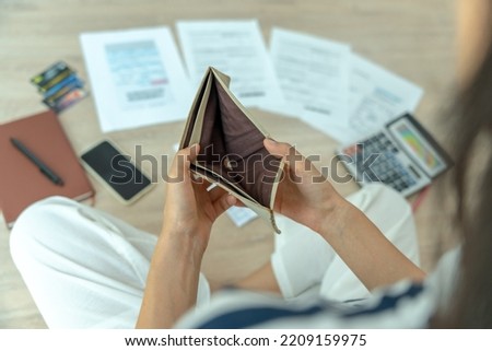 Women  managing debt and expenses. People holding wallet but no money to pay credit card.  broke, mortgage, loan, bankruptcy, bankrupt, can't to pay  Royalty-Free Stock Photo #2209159975