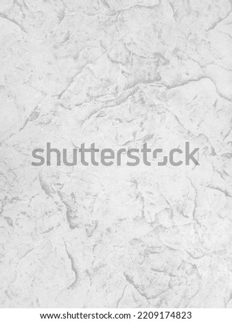 Rough white stone wall background in vintage style for graphic design or wallpaper. Pattern of soft nature floor in retro concept. Gray abstract texture detail in construction or exterior decoration.