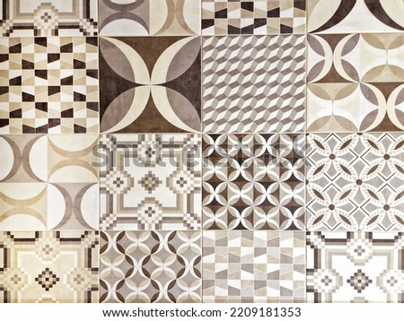 Patchwork patterned decor tile which features random semi-repeating patterns in white, brown and black colours