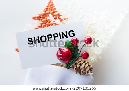 Shopping text on a card next to new jewelry on a white background