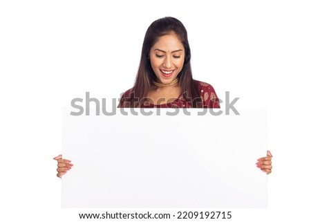 Indian young woman holding white board isolated on white.