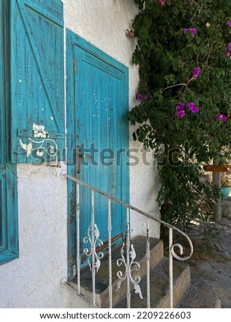 photo of blue colored door and blue colored window in resort on a hot summer day