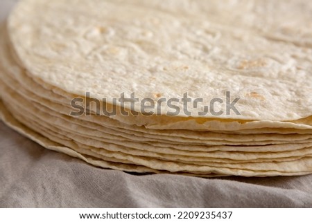 Homemade Wheat Flour Tortillas in a Stack, side view. Close-up.