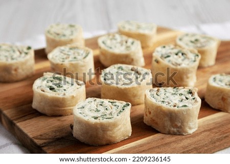 Homemade Pinwheel Tortilla Appetizers with Bacon, Spinach, Green Onion and Cream Cheese, side view. Royalty-Free Stock Photo #2209236145