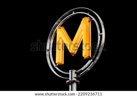 Illustration picture shows a sign with the subway logo (yellow symbol) in front of a parisian metro (metropolitain) station at night in Paris, France