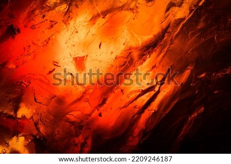 Amber macro abstract background texture, with inclusion detail, colorful yellow orange and red. unpolished rough raw specimen close-up Royalty-Free Stock Photo #2209246187