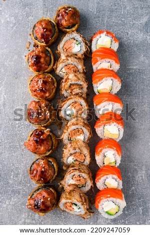 sushi rolls set of different colorful maki sushi rolls with tuna, salmon, shrimp, crab and avocado on a dark gray background