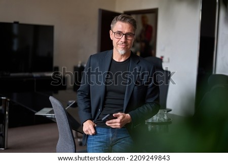 Portrait of confident businessman in business casual. Happy middle aged, mid adult, mature age man smiling. Entrepreneur in modern office. Royalty-Free Stock Photo #2209249843