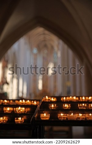 Burning candles in catholic church in the evening candle fire Royalty-Free Stock Photo #2209262629