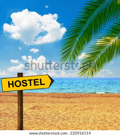 Tropical beach and direction board saying HOSTEL