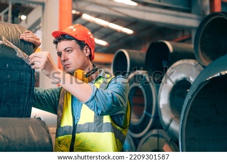 Smart confidence professional industrial engineer,operator worker with hard hat inspect, check roll of steel metal sheet at warehouse for quality control, maintenance, Manufacturing production factory Royalty-Free Stock Photo #2209301587