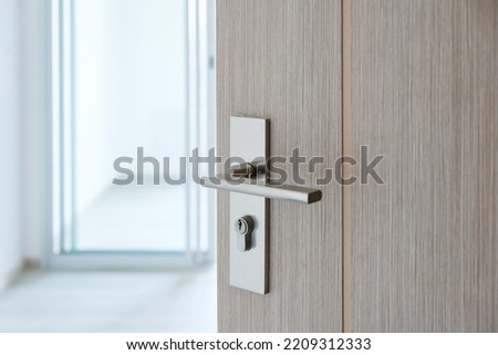 Closeup doorknob of wooden door between open or close the door Royalty-Free Stock Photo #2209312333