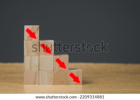 Stack wooden blocks with percentage symbol and arrow pointing down.Down Interest rate financial and mortgage rates concept. 