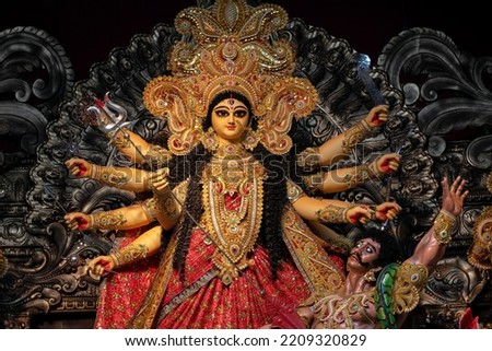 Idol of Goddess Devi Durga at a decorated puja pandal in Kolkata, West Bengal, India. Durga Puja is a famous and major religious festival of Hinduism that is celebrated throughout the world. Royalty-Free Stock Photo #2209320829