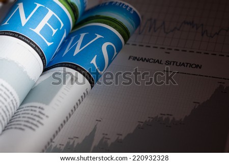Newspaper and financial situation report with very shallow depth of field - custom designed newspaper.