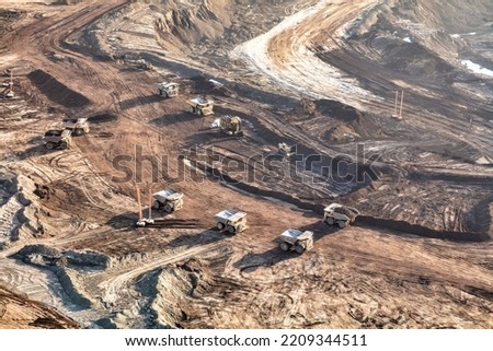 Aerial view of giant dump trucks collecting newly mined Oilsand from Athabasca Tar sand site being processed in local Petrochemical refineries Alberta travel Royalty-Free Stock Photo #2209344511