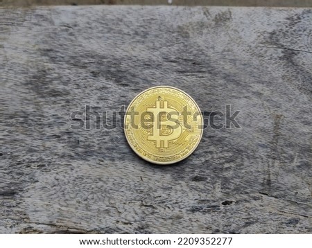 Golden Bitcoin coin on a wooden background. Crypto currency of Bitcoin