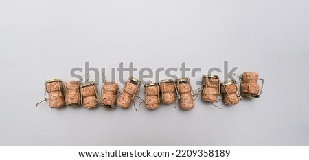 Champagne corks and metal wire muselets on grey background. Collection of bottle caps from sparkling wine . Royalty-Free Stock Photo #2209358189