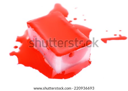 Watercolor paint cube and spilled paint isolated on white