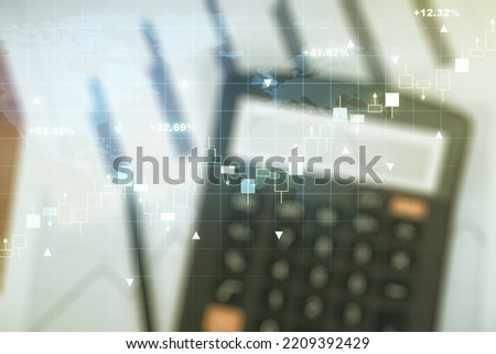 Abstract creative financial graph and world map on blurry calculator and papers background, financial and trading concept. Multiexposure