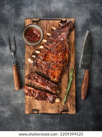 Delicious smoked pork ribs glazed in BBQ sauce. Top view. Royalty-Free Stock Photo #2209394525
